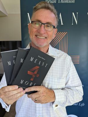 Brian Thomson holding books