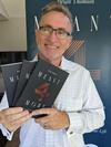 Brian Thomson holding books